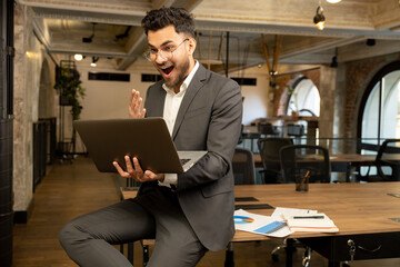 Young manager looking excited after receiving a good news