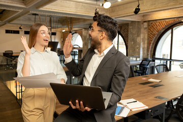Colleagues in the office discussing project details and looking involved