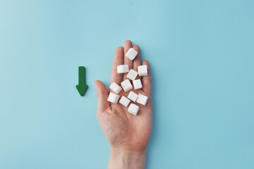 Conceptual arrow with cubes and an arrow that reduces blood sugar consumption
