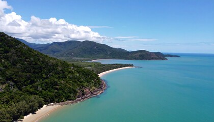 Naklejka premium Lush coastline with turquoise water and mountains