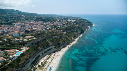 Coastal Cliffside Town with Red Roofs and Blue Sea