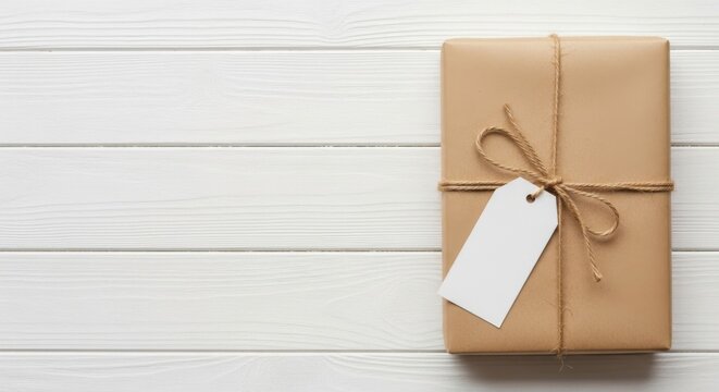 Gift box with tag on white wood background, package, present and wrapped delivery