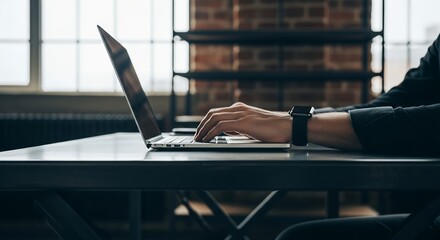 Close-up of hands typing on laptop keyboard. Modern workspace with no face visible. Suitable for business, freelance, tech, or remote work concepts.
