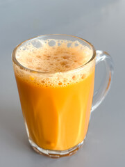 Teh tarik served in a clear glass mug, Malaysia’s iconic pulled milk tea with frothy top and rich, sweet aroma.