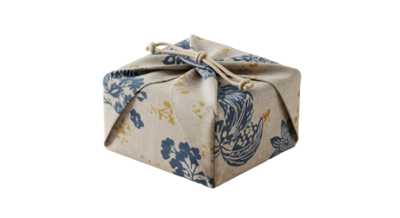 Decorative gift wrapped in fabric with floral print and tied bow  