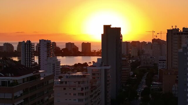 Aerial View Of Calpe City In Spain, Cityscape and Skyline At Sunset With Estimar Hotel And Buildings