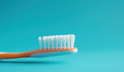 Close-up of toothbrush on solid blue background with copy space, showcasing minimalist dental care concept for oral hygiene or smile cleaning advertising template