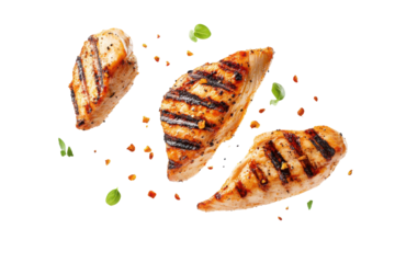 Grilled chicken strips with parsley and spices isolated on transparent background. Flying pieces of delicious grilled chicken isolated on white background.
