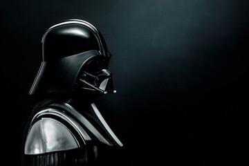 Naklejka premium Closeup of Darth Vader action figure character from the Star Wars movie saga and space for text. Illustrative editorial