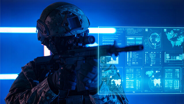 A soldier in tactical gear aiming weapon and using advanced digital interface to gain data - Powered by Adobe