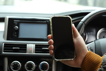 Driver searches for directions using mobile phone in car