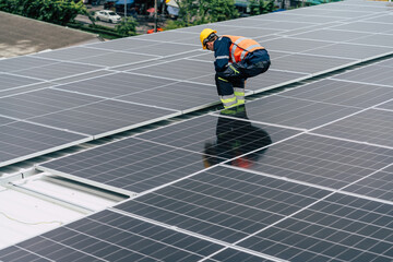 Worker installs solar panels on a rooftop at a commercial building during daylight hours