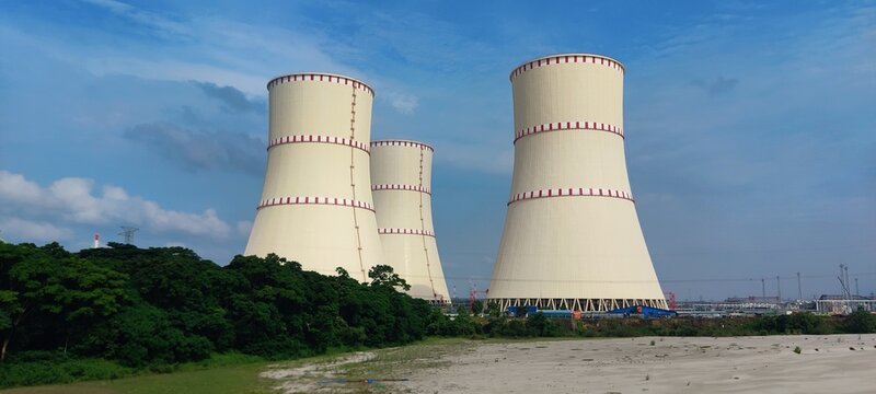 Bangladesh, Ruppur - 26.06.2025: The bank of Ganges River, Padma with cooling towers of Rooppur Nuclear Power Plant under construction in the background.