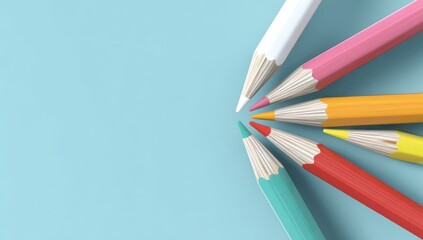 Colorful pencils arranged in a semi-circle on a light blue background, points facing inward towards an empty center space. Shallow depth of field