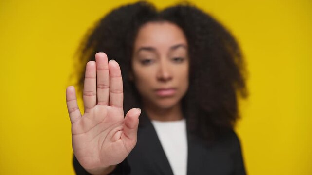 Serious woman making stop gesture with hand