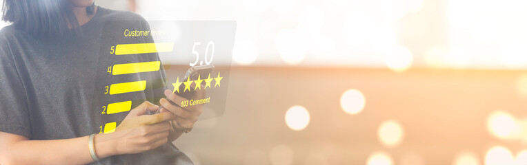 Customer using smartphone to give 5 star review with happy face icon. Customer satisfaction, feedback, and digital service quality concept.