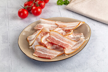 Raw pork tenferloin with bacon