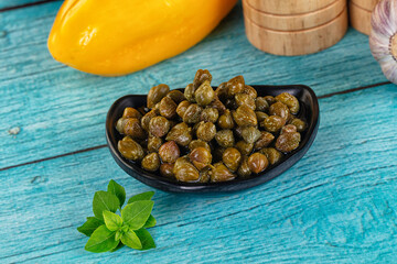 Pickled canned capers in the bowl