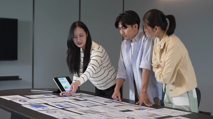 Group of professional asian business meeting and discussing with new startup idea project.Creative business people planning strategy analysis and brainstorm with document report in office.Teamwork - Powered by Adobe
