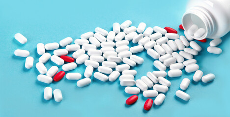 Heap of pills on blue background