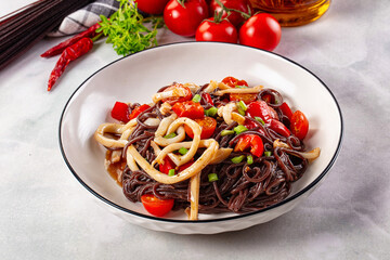 Black rice pasta with squid and tomato
