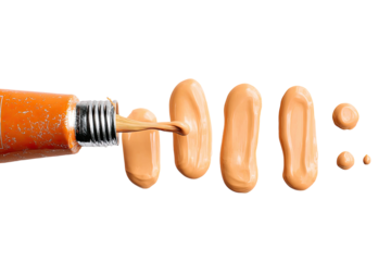 Orange tube of liquid foundation dripping, creating streaks