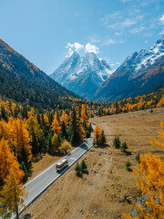 Aerial view of  Couple tourist relaxing  at  Mount Siguniang national park with the Beautiful  snow...