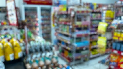 Abstract defocused background of a minimarket or convenience store. Blurred minimarket shop