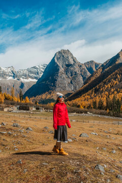 young  tourist explore and relaxing  at  Mount Siguniang national park with the Beautiful  snow mountains in autumn, Chengdu ,Sichuan in China.