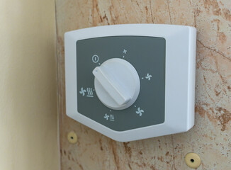 The ventilation intensity control panel of the climate control system mounted on the wall