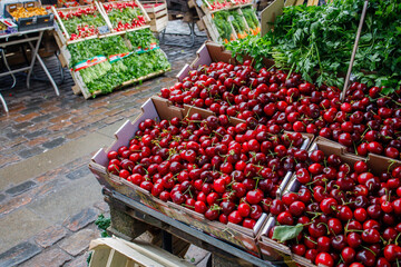 Fresh wild cherries sold on farmers market. Healthy nutrition with local seasonal berries.
