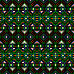 Dynamic geometric tribal pattern with vibrant green, red, and blue tones on a black background. This seamless ethnic design is ideal for modern fashion, digital projects, and cultural-themed prints.