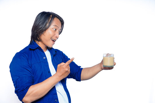 The young Asian man with a blue shirt and a white shirt smiled broadly Sabil pointed at a glass of milk coffee he was holding.