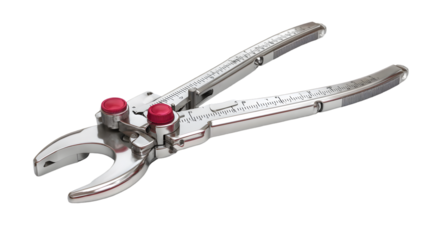A close up of a metal tool with red buttons and measurement markings on a black background studio shot