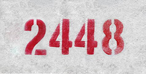 Red Number 2448 on the white wall. Spray paint.