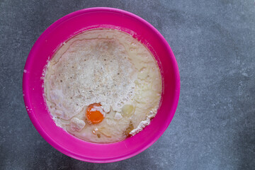 top view of mixed baking ingredients with yeast in a bowl