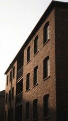 Fototapeta premium Brick Building with Arched Windows and Balconies