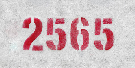 Red Number 2565 on the white wall. Spray paint.