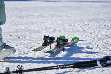 Alpine skis and ski poles on snow at ski resort