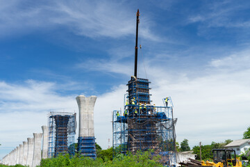 Workers construct bridge piers for a railway.
