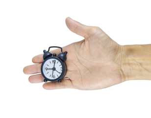 A close-up of a human hand holding a small clock, symbolizing the importance of time. The image conveys a message about time management and how every second counts