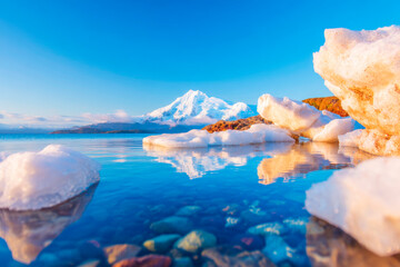 Ice floes drifting on calm glacial lake with mountain silhouette serene arctic landscape
