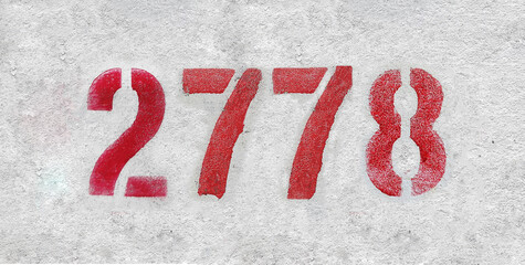 Red Number 2778 on the white wall. Spray paint.