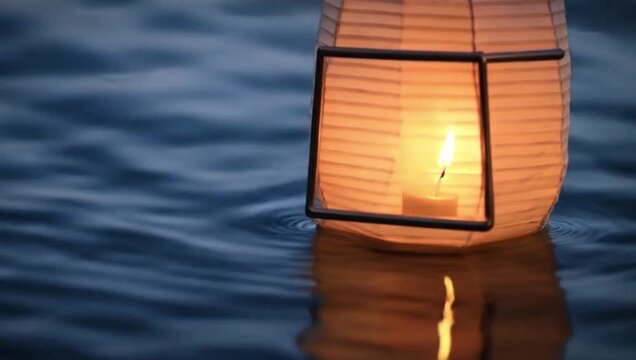 A Chinese lantern sways on the small ripples. 