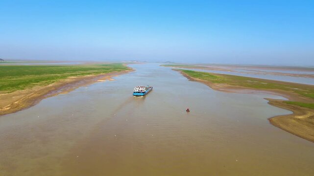 Exploring poyang lake's stunning channel with shipping activity amidst vast nature