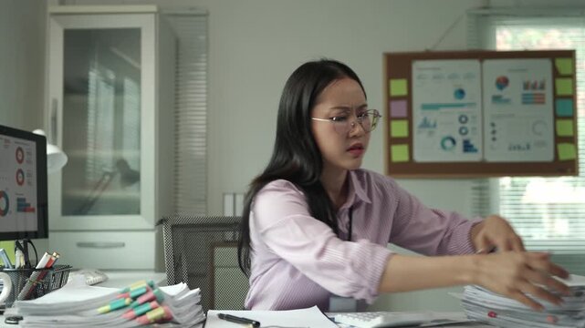 Overwhelmed business professional searching frantically through large stack of documents, experiencing high pressure workplace stress while attempting to meet critical deadline