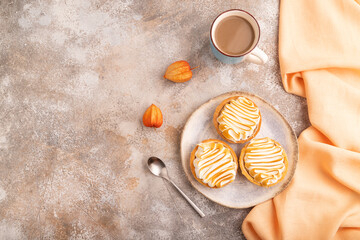 French lemon tart with meringue on brown concrete, orange linen textile, top view, flat lay, copy space
