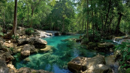 Lush tropical river flowing through a dense forest.  Crystal-clear turquoise water, rocky banks, and waterfalls