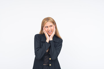An irritated young Asian woman covering her ears with both hands while looking to the side in...