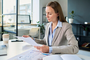 Manager or analyst working with financial documents in office